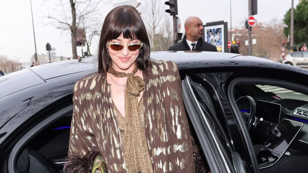 Dakota Johnson Stuns in Sheer Lace Shorts & Patterned Tights at Paris Fashion Week