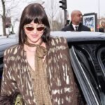 Dakota Johnson Stuns in Sheer Lace Shorts & Patterned Tights at Paris Fashion Week