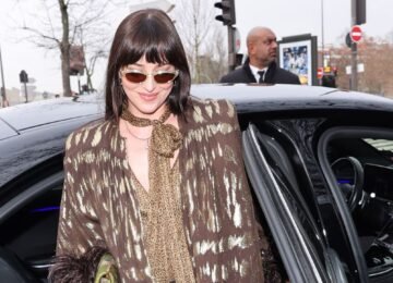 Dakota Johnson Stuns in Sheer Lace Shorts & Patterned Tights at Paris Fashion Week