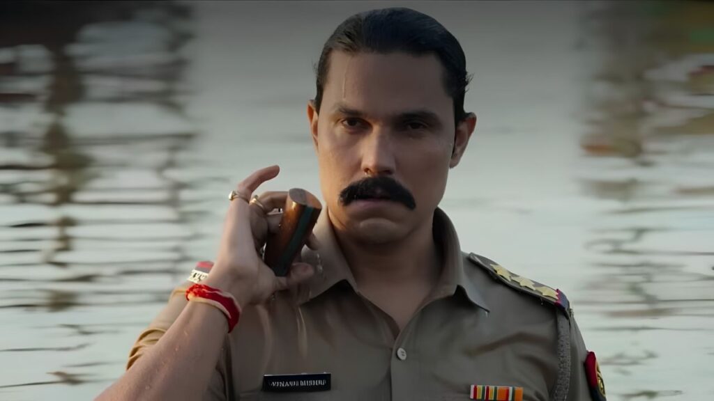Inspector Avinash Season 2 trailer is finally out, and it promises a far more intense, emotional and explosive chapter in the crime thriller franchise. Led by Randeep Hooda, the upcoming season raises the stakes with bigger action, personal conflict and a dangerous nexus of crime, politics and corruption. After the strong response received by the first season, fans had been eagerly waiting for the next chapter. Going by the newly released trailer, the wait looks worth it. This time, Inspector Avinash Mishra is not only fighting criminals but also battling threats that hit dangerously close to home. Inspector Avinash Season 2 Trailer Promises High-Stakes Drama The trailer opens in the tense landscape of 1990s Uttar Pradesh, instantly setting the gritty tone of the series. It wastes no time in showing that Avinash Mishra is entering the most difficult phase of his life. His son is implicated in a murder case. His marriage is under severe strain. Meanwhile, powerful enemies are closing in from every direction. Unlike the first season, where Avinash largely fought external threats, the second season appears far more personal. The emotional stakes are clearly deeper, making this story feel bigger than a standard action thriller. Randeep Hooda Returns In Powerful Form Randeep Hooda once again steps into the role of Inspector Avinash Mishra, and the trailer suggests another commanding performance. Known for bringing intensity and realism to his characters, Hooda appears fully in control of the role. His screen presence, restrained anger and emotional weight give the trailer much of its impact. Speaking about the new season, the actor shared that this chapter strips Avinash down to his core. He is now fighting for family, truth and survival rather than simply enforcing the law. That shift could make the character more layered and emotionally compelling. Crime, Politics And Corruption Drive The New Story One of the strongest elements in the trailer is the expansion of the larger criminal world. This season introduces a more dangerous network involving crime lord Sheikh and the mysterious Devi. Together, they are shown building a deadly weapons cartel while manipulating power structures around them. As a result, the story goes beyond gang rivalry and police action. It enters a darker space where politics, betrayal and institutional corruption become central themes. This broader conflict can elevate the season into a more gripping and layered crime saga. Avinash Faces Betrayal From Within Perhaps the most dramatic twist teased in the trailer is that Avinash is not just targeted by criminals. He is betrayed from inside the system. The footage shows him suspended, arrested and isolated. This suggests that trusted allies may turn into enemies, while official systems become weapons against him. That kind of narrative often creates stronger tension because the hero has nowhere safe to turn. It also means Avinash may need to break rules or operate outside the system to survive. Strong Supporting Cast Adds Depth The series features a solid ensemble cast that can significantly strengthen the drama. Key Cast Members Include: Urvashi Rautela Amit Sial Abhimanyu Singh Rajneish Duggal Shalin Bhanot Freddy Daruwala Each actor brings a distinct screen presence, and their involvement hints at multiple subplots, layered conflicts and power struggles. Urvashi Rautela described the new season as bigger, bolder and more explosive, adding that every scene pushes the intensity further. Why The 1990s Setting Still Works The decision to keep the story rooted in 1990s Uttar Pradesh remains one of the series’ smartest creative choices. That era was marked by political instability, growing organised crime and shifting power centres. It naturally suits stories involving gang networks, corrupt systems and larger-than-life law enforcement figures. The period backdrop also adds texture through costumes, production design, vehicles and atmosphere, helping the show stand apart from present-day crime dramas. What Fans Can Expect From Season 2 Based on the trailer, viewers can likely expect: Bigger action sequences Emotional family drama Political conspiracies Suspenseful betrayals Powerful villain arcs Gritty 90s atmosphere Randeep Hooda in peak form This combination can help the new season appeal to both action lovers and fans of layered storytelling. Streaming Date Confirmed The makers have officially announced that Inspector Avinash Season 2 will premiere on JioHotstar on May 15. With the trailer now out, audience anticipation is expected to rise sharply over the coming days. Final Verdict Inspector Avinash Season 2 trailer successfully builds excitement by offering a darker, more personal and more explosive continuation of the story. Randeep Hooda looks intense, the stakes feel higher and the larger crime-political nexus adds serious intrigue. If the full season delivers on the promise of the trailer, this could become one of the most talked-about Indian crime thrillers of the month. For fans of hard-hitting action dramas with emotional depth, Inspector Avinash Season 2 looks like a must-watch.